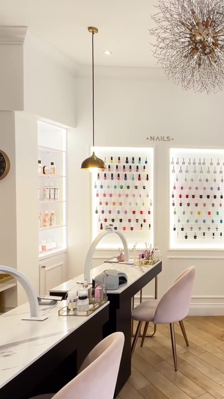Nail bar with manicure tables and pink chairs