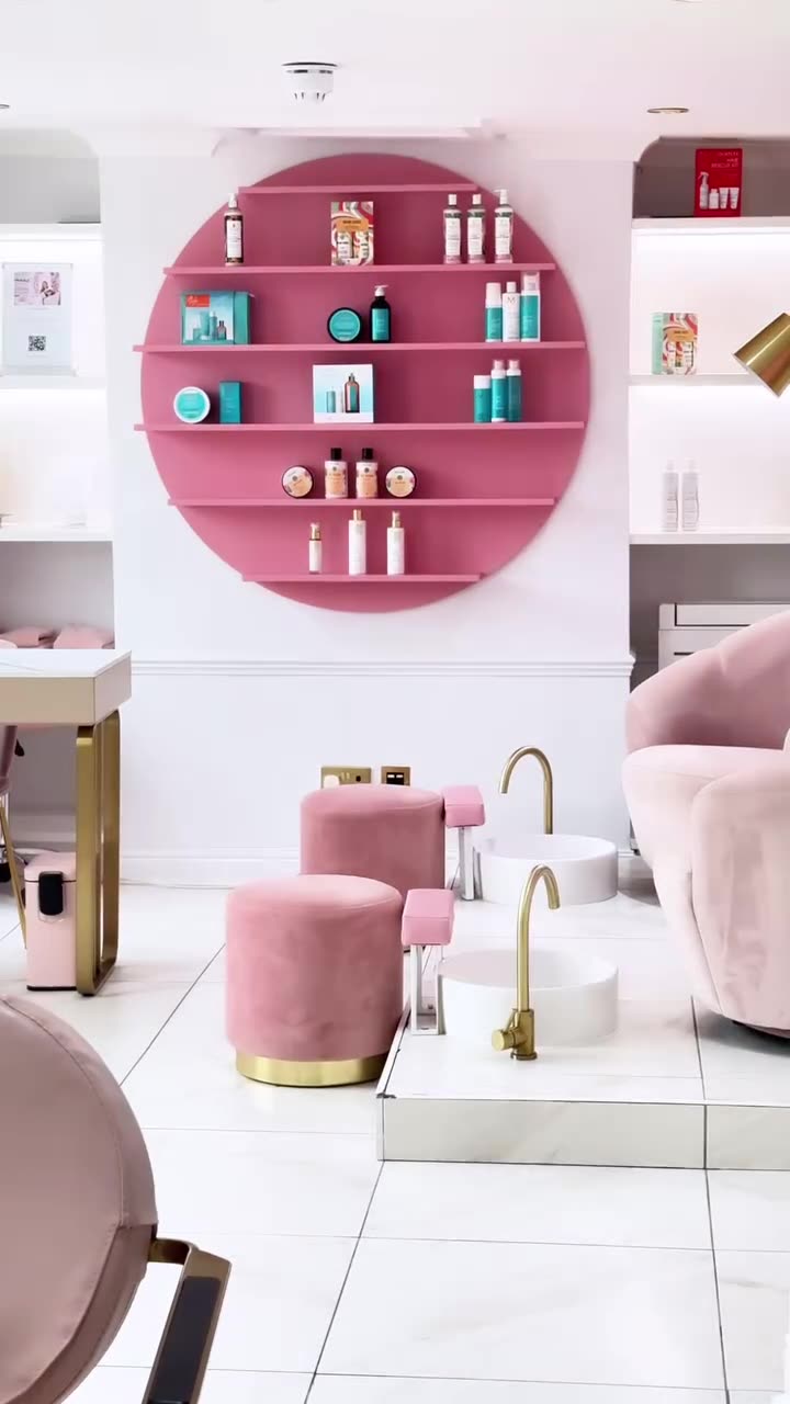 Pink room with a round shelf of products and pink stools