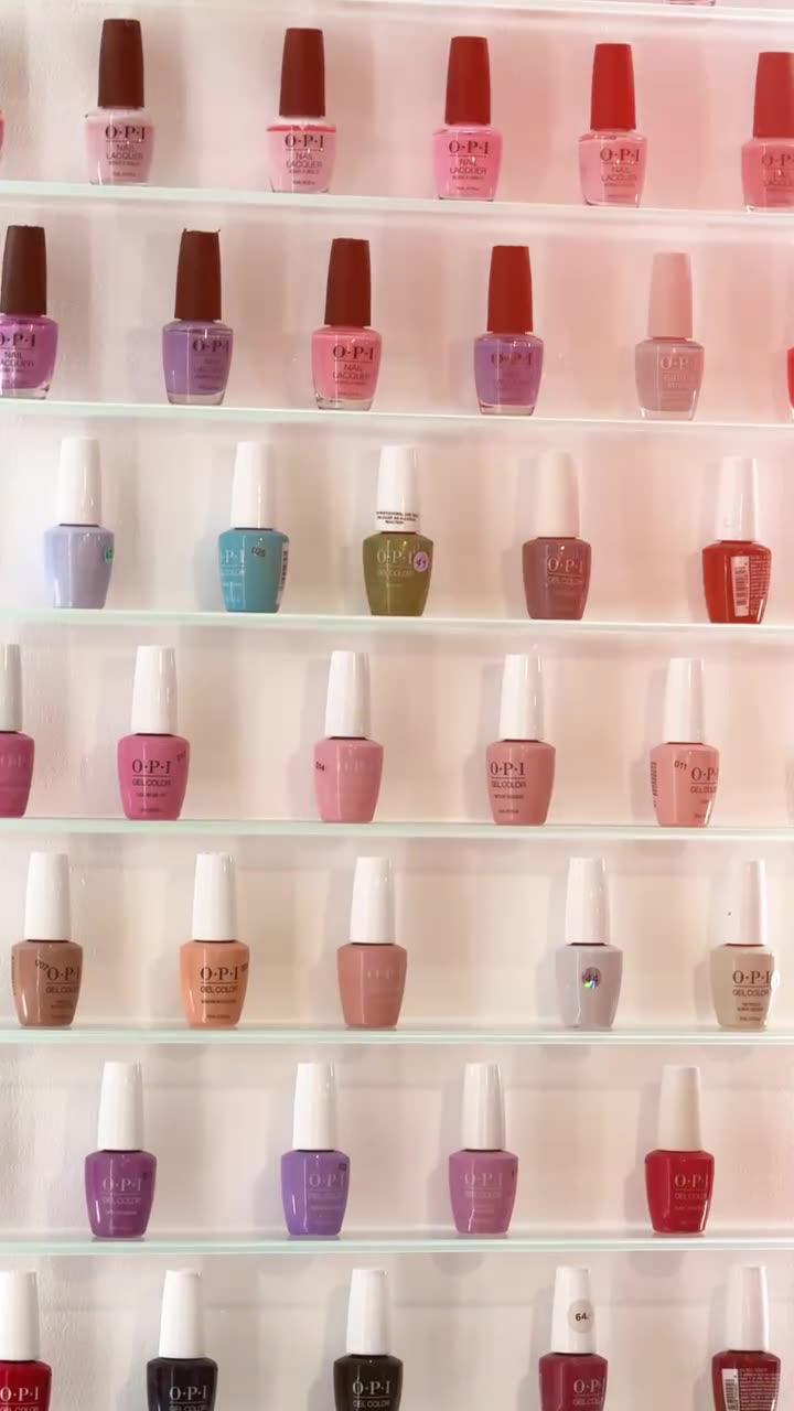 Wall of nail polish bottles in pinks and nudes