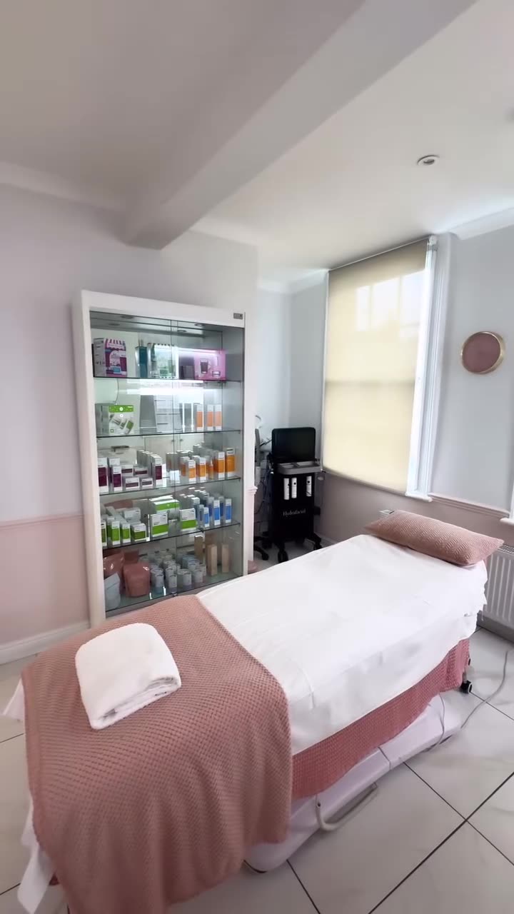 Treatment room with a couch, towels and a skincare display